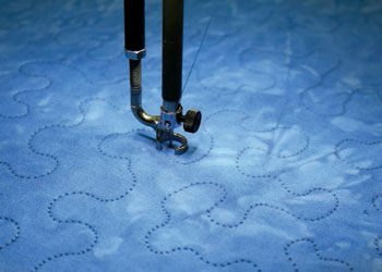 Learn to quilt including free-motion stitch with this free eBook.