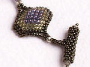 Lucky Diamonds bracelet by Glorianne Ljubich Odd-count peyote stitched domed diamond shapes are linked with ladder stitch and amethyst bicone crystals