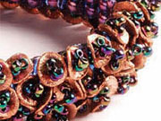 Sequin Shimmer by Cindi Slater A square stitch foundation with beaded fringe made of copper discs and amethyst seed beads
