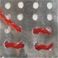 Punched with a paper punch; yarn threaded through.