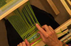 Jane Patrick weaves ribbon and lace on her rigid heddle loom
