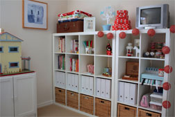 Lots of storage keeps everything organized in a studio that also functions as a guest room. Lots of storage keeps everything organized in this sewing studio that also functions as a guest room.