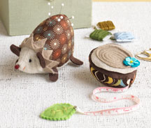 Hedgehog Pincushion and Tree-Stump Tape Measure by Heidi Boyd. Hedgehog Pincushion and Tree-Stump Tape Measure by Heidi Boyd.