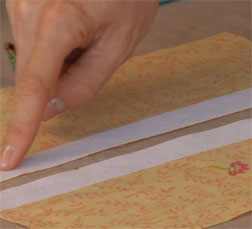 Add interfacing to seam allowances before sewing a zipper.